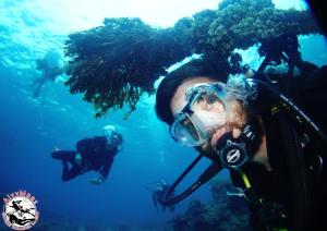 a man in a diving mask in the water at AivyMaes Divers Resort in Dauin