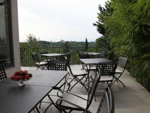 a group of tables and chairs on a patio at Dvor Apartments and Rooms in Dobrovo