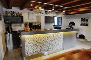 a kitchen with a counter with a stone wall at Dvor Apartments and Rooms in Dobrovo