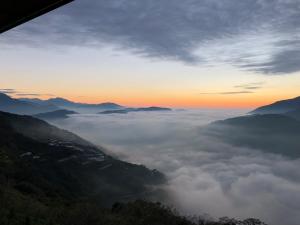 a view of a valley of clouds at sunset at Top Cloud Villa in Renai