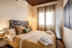 a bedroom with a large bed with towels on it at Lances Beach Penthouses in Tarifa