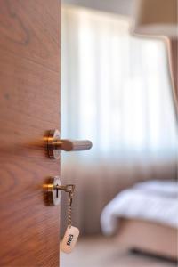 a door with a key in a room with a bed at Boulevard Prishtina in Pristina