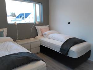 Ένα ή περισσότερα κρεβάτια σε δωμάτιο στο Post-Plaza Guesthouse