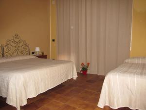 Łóżko lub łóżka w pokoju w obiekcie Hotel Panorama di Sicilia