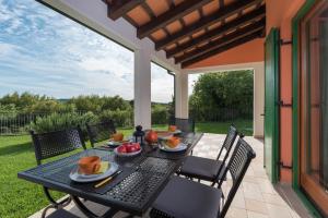 a table with fruit on it on a patio at Apartments Athos in Rabac