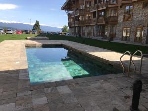 a swimming pool in front of a building at Pirin Golf Villa Emila in Bansko
