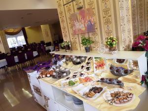 a table with plates of food on top at Hotel Elit Palace and SPA in Balchik
