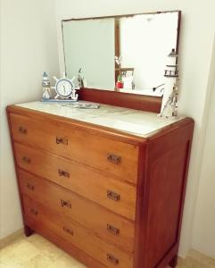 a dresser with a mirror on top of it at B&B Faro Bianco in Otranto