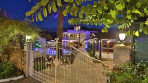 a white fence in front of a house at night at B&B Boutique Hotel in Dalyan