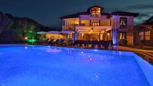 a large swimming pool in front of a house at night at B&B Boutique Hotel in Dalyan