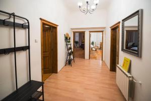 a hallway with a staircase and a mirror at Renesanční vinařský dům v historickém centru Znojma in Znojmo