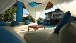 a patio with couches and a table and a pool at B&B Boutique Hotel in Dalyan