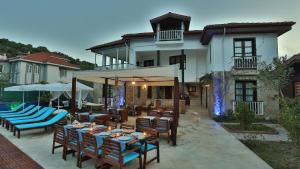 a restaurant with blue tables and chairs in front of a building at B&B Boutique Hotel in Dalyan