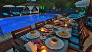 a table with food next to a swimming pool at B&B Boutique Hotel in Dalyan