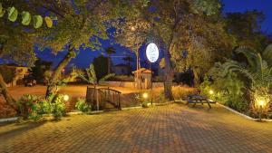 a park with a bench and a clock tower at night at B&B Boutique Hotel in Dalyan