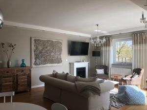 uma sala de estar com um sofá e uma televisão em Im Feldle em Kirchheim am Ries