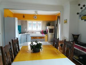 a kitchen with a dining table and a white refrigerator at Appartement Ria in Ria