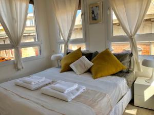 a bedroom with two towels on a bed with windows at Altana Bologna in Bologna