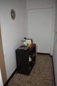 a small black desk in a room with a white wall at Appartamento Paola in Mestre