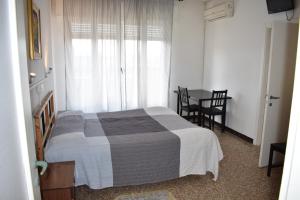 Un pat sau paturi într-o cameră la Appartamento Paola