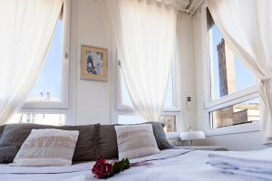 a bedroom with a bed and two large windows at Altana Bologna in Bologna