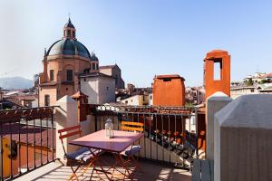 a table on a balcony with a view of a city at Altana Bologna in Bologna