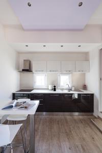 a kitchen with black and white cabinets and a table at Altana Bologna in Bologna
