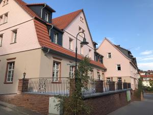 Une rangée de maisons roses et blanches dans une rue dans l'établissement Gasthof zum Ochsen, à Hammelbach