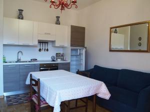 a kitchen with a table and a blue couch at Villa Wanda in Cavalese +10 photos