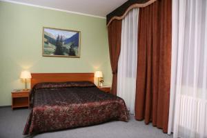 AZIMUT Hotel Rostov Veliky tesisinde bir odada yatak veya yataklar