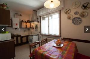 a kitchen with a table with a bowl of fruit on it at Casa Murazzi in Venice-Lido