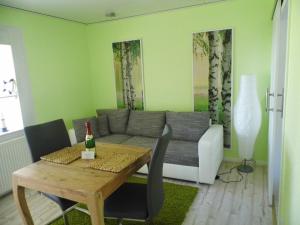 a living room with a couch and a table at Ferienwohnung Seerose in Neppermin +35 photos