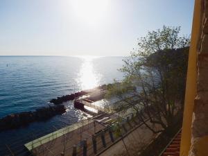 a view of a body of water with the sun shining at Villa Tergeste in Trieste