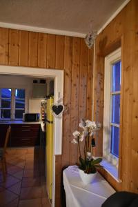 a kitchen with a refrigerator and a table with flowers on it at Ferienwohnung Domäne Süpplingenburg in Süpplingenburg