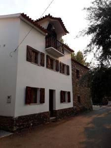 ein weißes Gebäude mit Fenstern und einem Balkon in der Unterkunft Casa do Rio 2 - Viver o rio e a montanha in Janeiro de Baixo