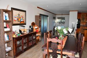 a dining room with a table and chairs at Cove View B&B in East London