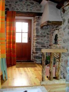 a living room with a door and a wooden floor at Arcogite in Vicdessos