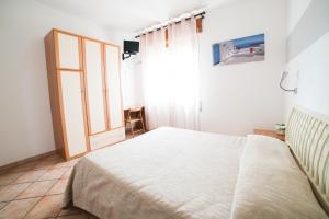 Postel nebo postele na pokoji v ubytování Hotel da Renato