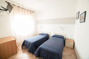 Postel nebo postele na pokoji v ubytování Hotel da Renato