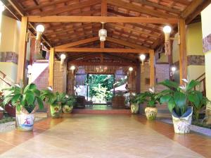 
a large room with a lot of plants in it at Pousada Canto de Itamambuca in Ubatuba
