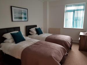um quarto com 2 camas e uma janela em Norfolk House em Southampton