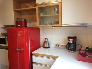 a kitchen with an old red refrigerator in a kitchen at Horto Terapeutico Home in Desenzano del Garda