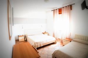 Postel nebo postele na pokoji v ubytování Hotel da Renato