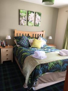a bedroom with a bed with towels on it at Christiesholidayhomes in Aviemore