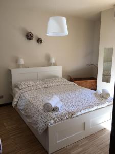1 dormitorio con 1 cama con toallas en Horto Terapeutico Home, en Desenzano del Garda