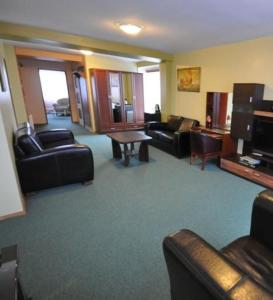 a living room with couches chairs and a table at Hotel Šiauliai in Šiauliai +10 photos
