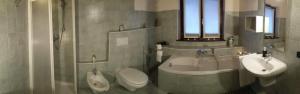 a bathroom with a toilet and a sink at Ai Tre Portoni in Trento