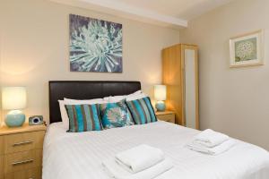 a bedroom with a bed with two towels on it at Hamilton Court Apartments from Your Stay Bristol in Bristol
