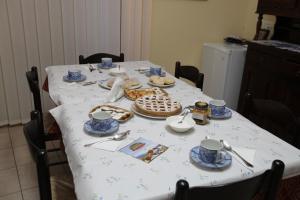 a table with blue and white plates and cups on it at B&B DEL CORSO in Gangi