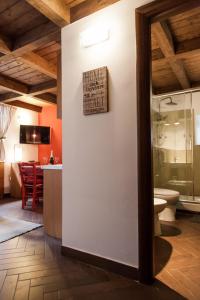 a bathroom with a toilet and a sign on a wall at Monolocale il Tindaro in Catania